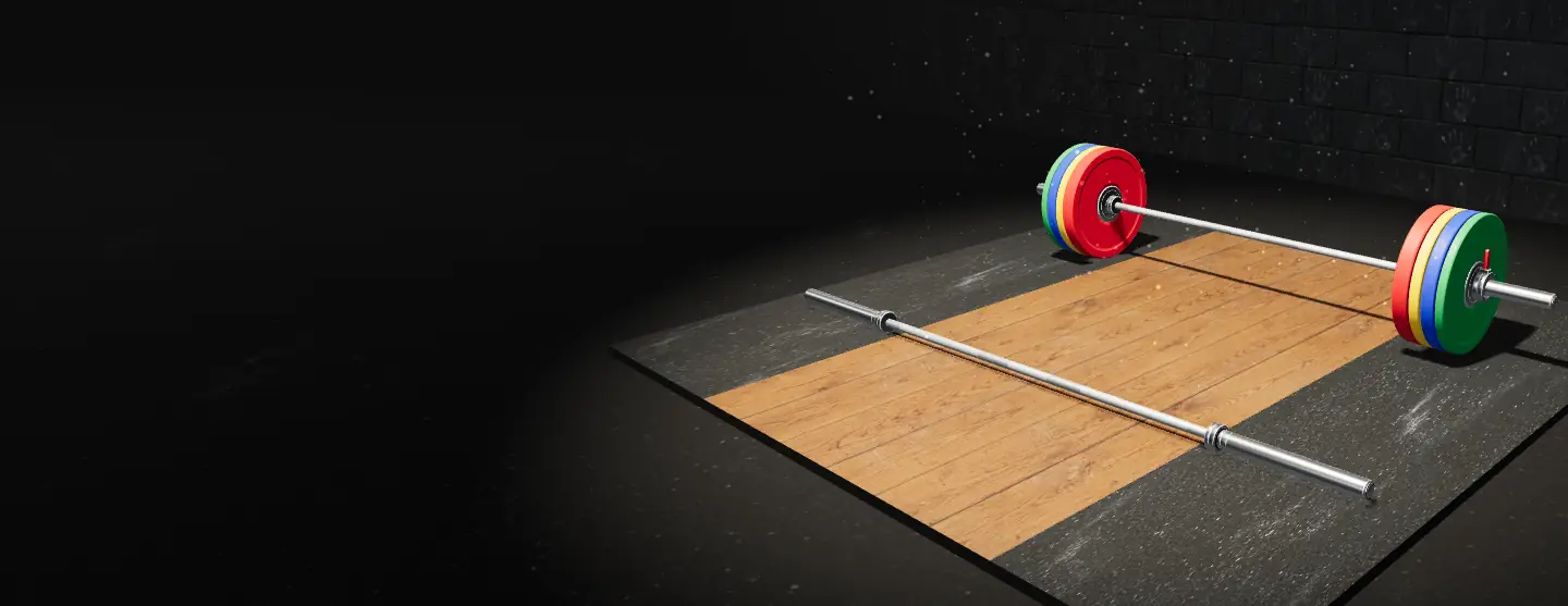 An empty barbell in front and a barbell loaded with red, yellow, blue and green plates behind it